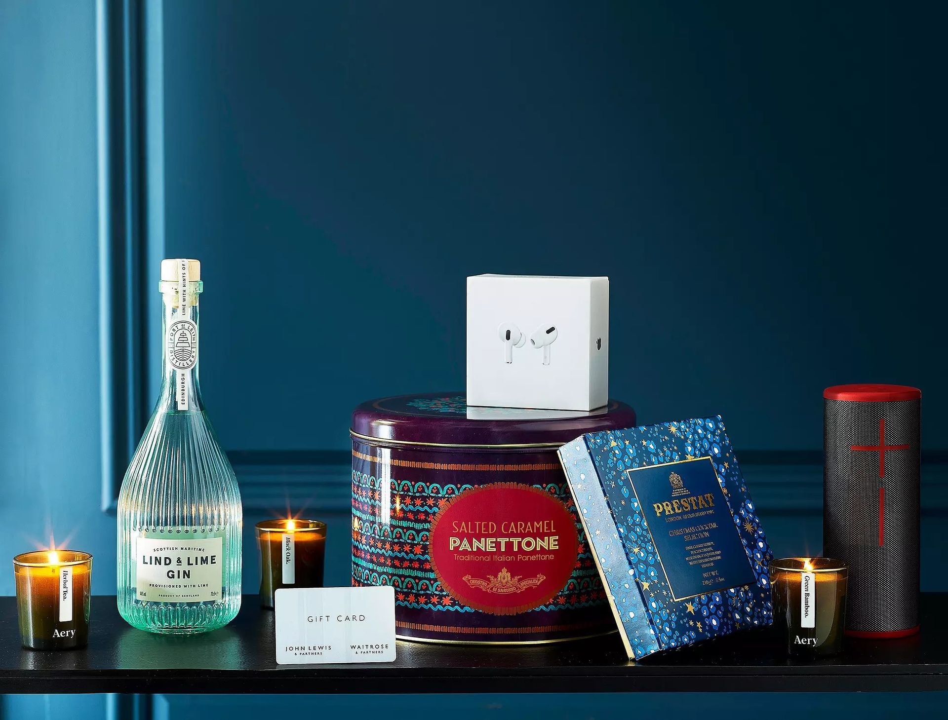 A table with a bottle of alcohol and candles on it