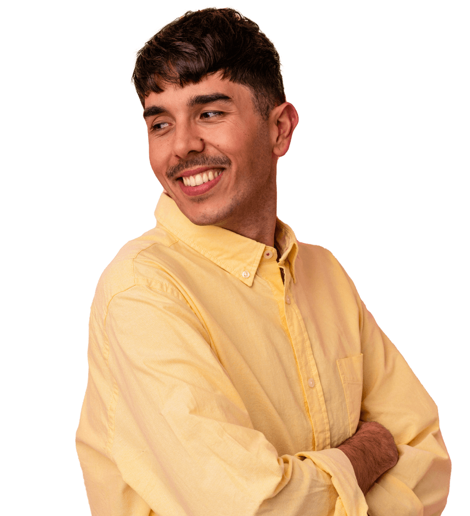 Person in a yellow shirt smiles and looks to their side with arms crossed.