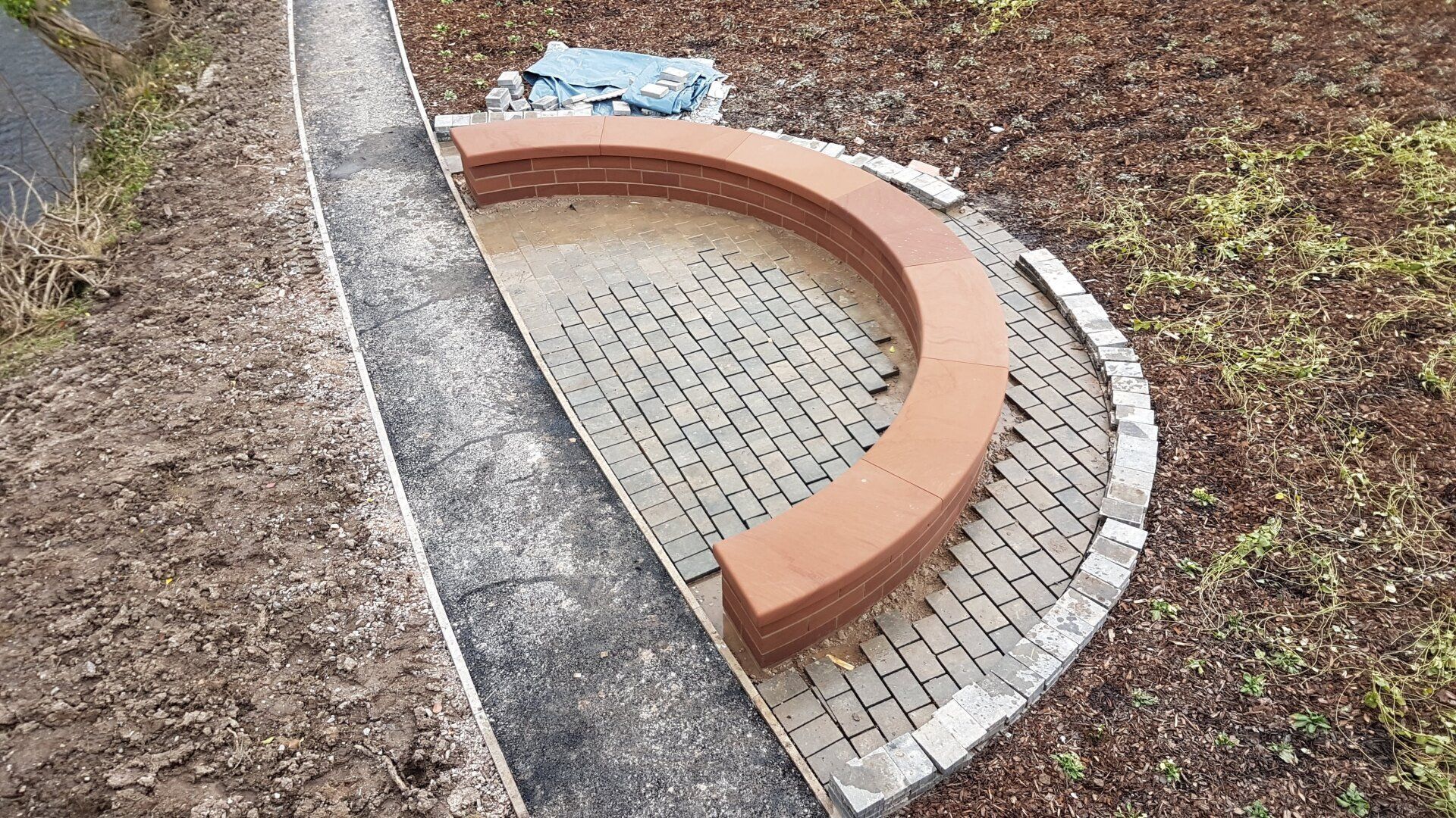 Large curved bench in St Asaph North Wales made from red sandstone