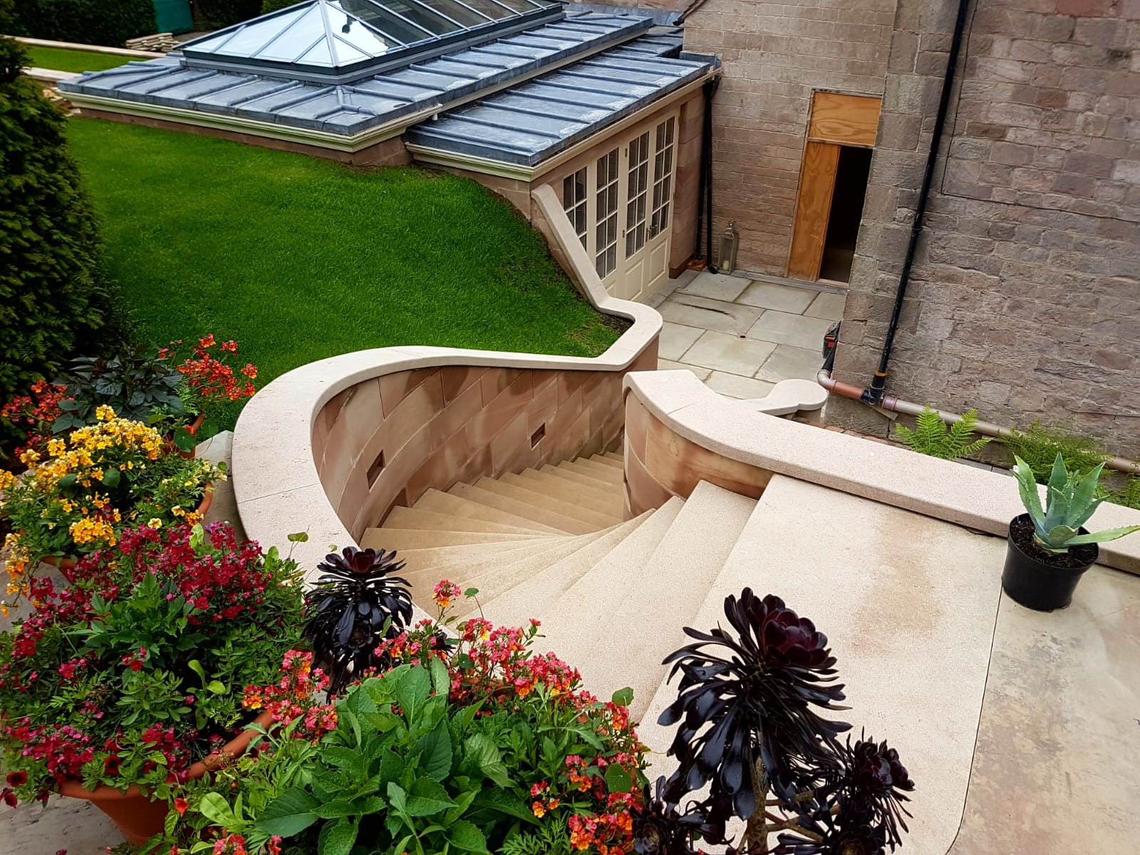 Beautiful curved staircase made from buff Derbyshire sandstone