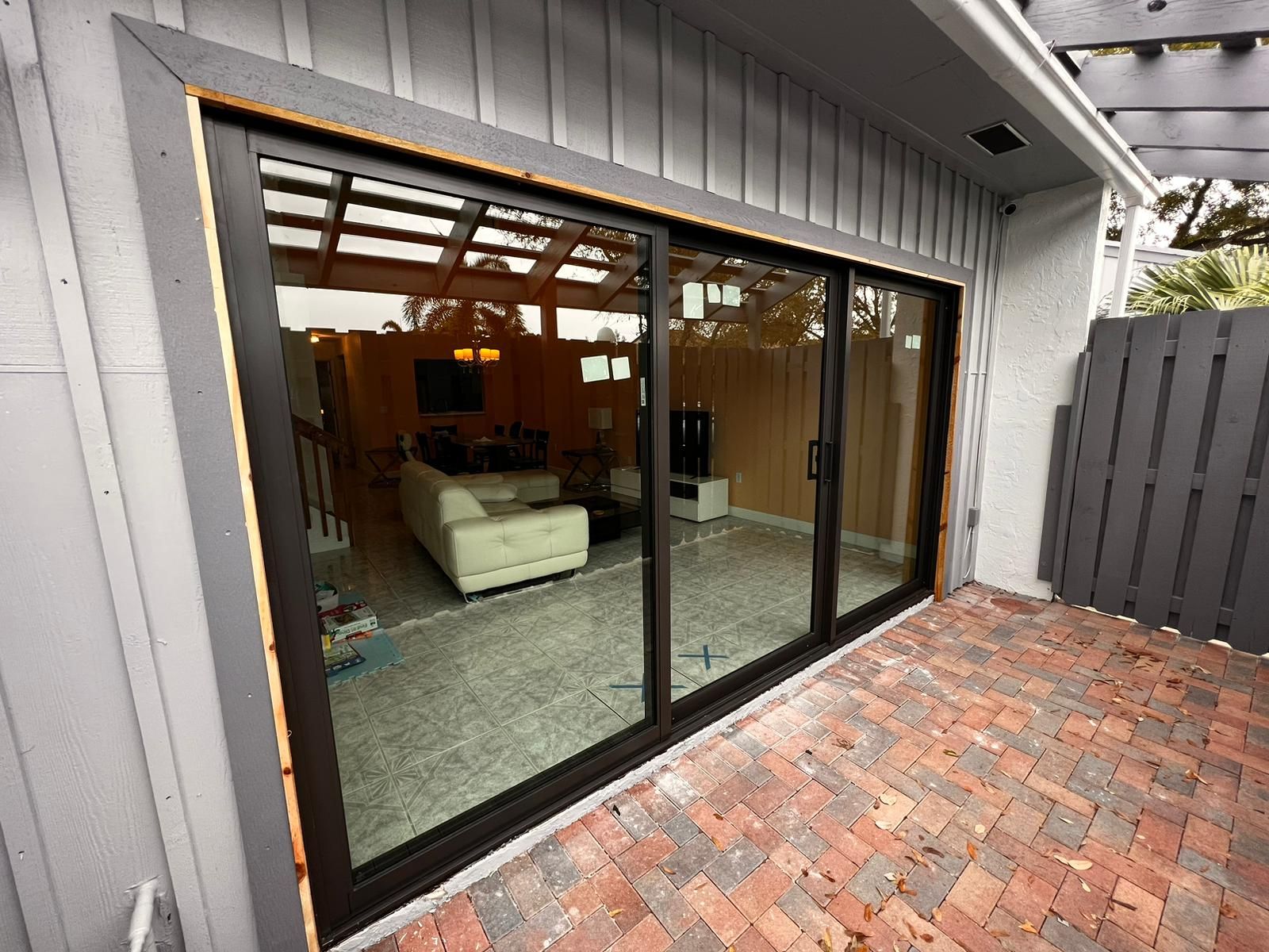 A sliding glass door is open to a living room.