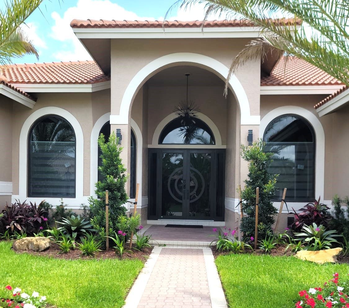 A large house with a walkway leading to the front door.