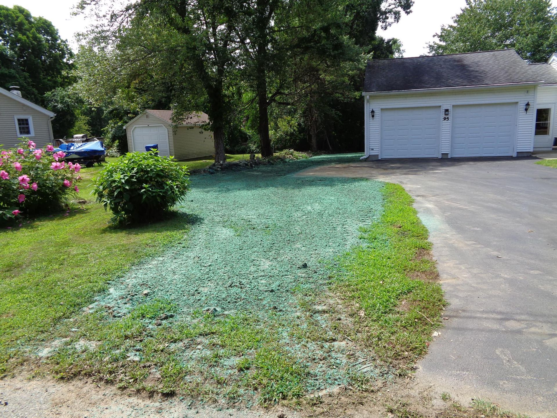 A man is giving a box to a woman in front of a van full of boxes