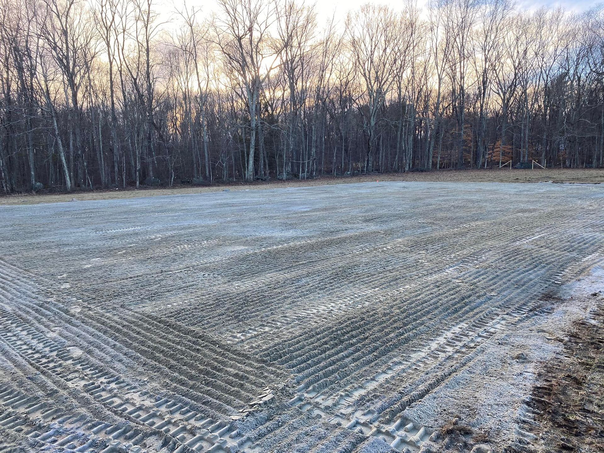 A man wearing a mask is carrying a cardboard box into a van.