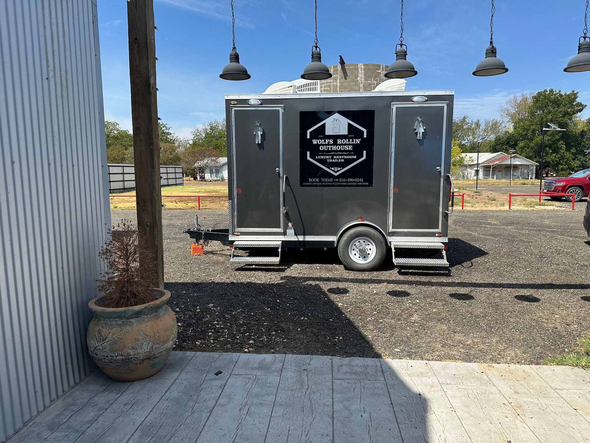 A trailer is parked in a parking lot next to a building.