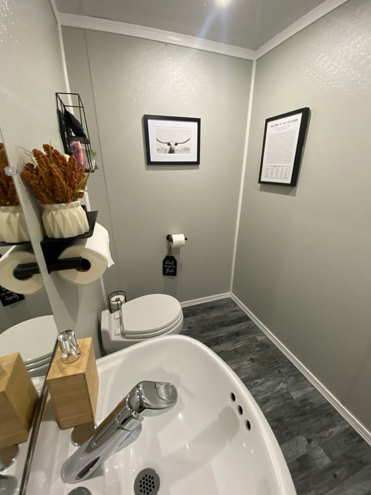 A bathroom with a sink , toilet and mirror.