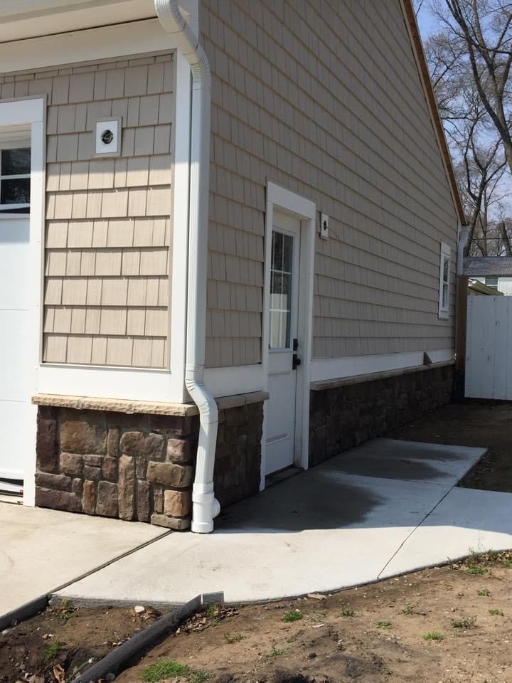 The side of a house with a white garage door
