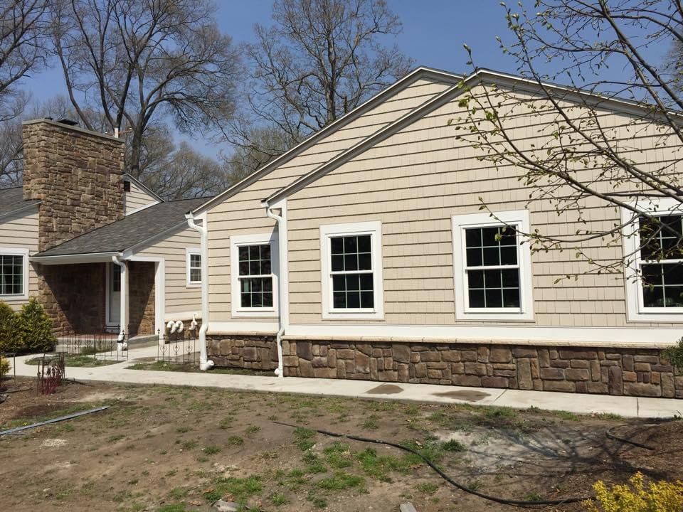 A house with a lot of windows and a chimney