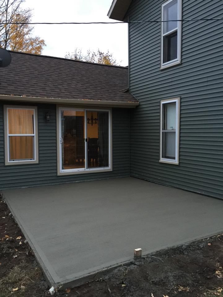 A house with a concrete patio in front of it