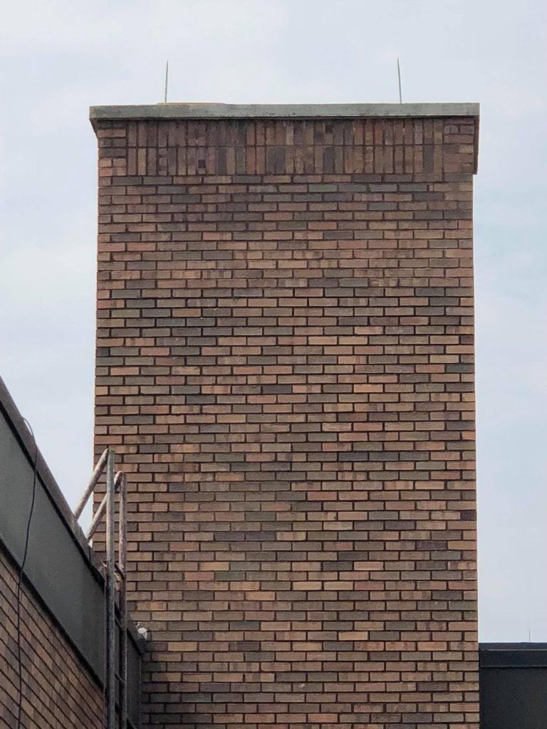 A large brick chimney on the side of a building