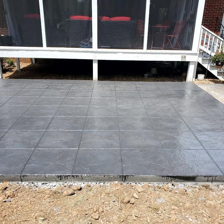 Gray tiled patio under a screened porch, with steps and exposed foundation.