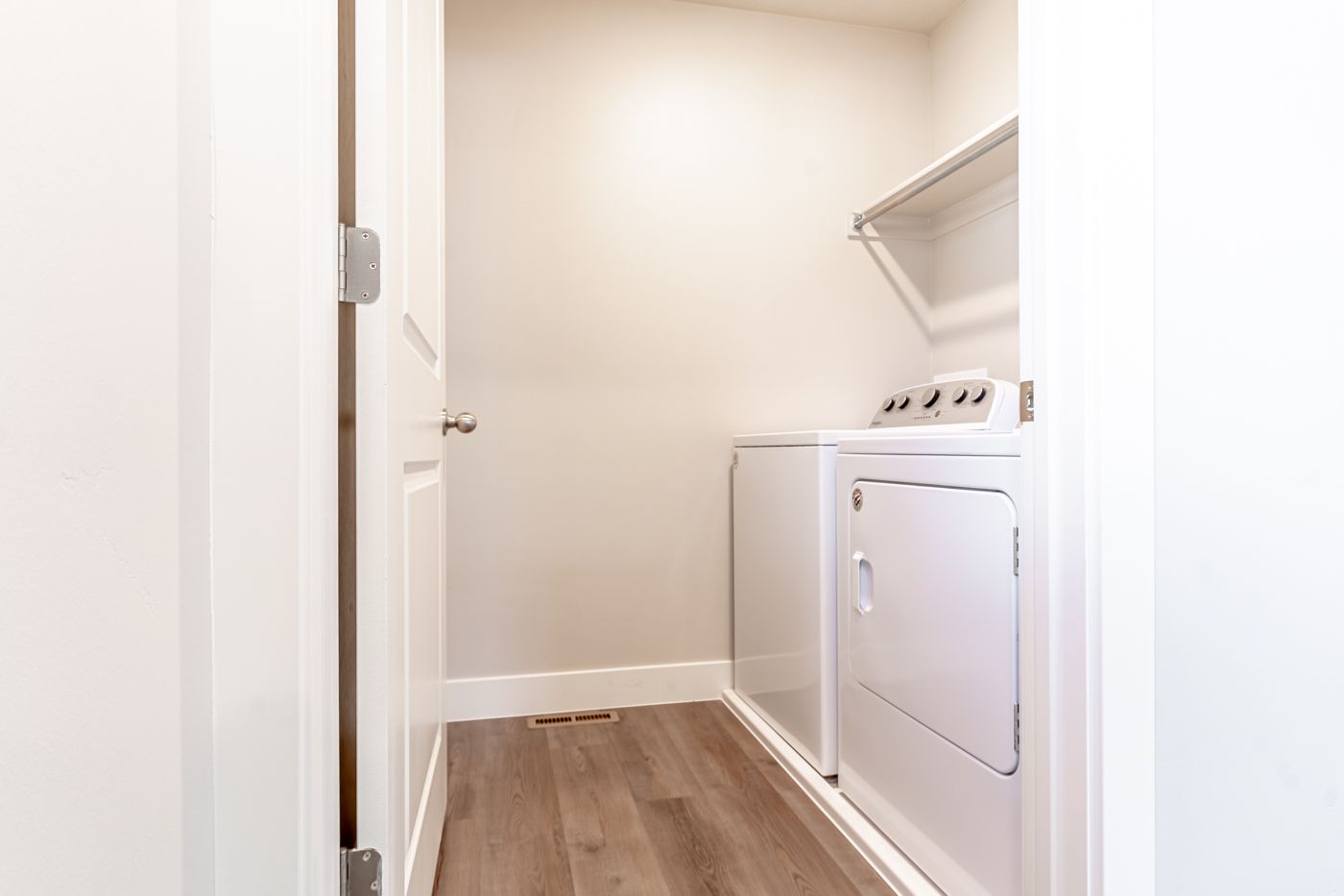 Compact laundry closet with a washer and dryer side by side.