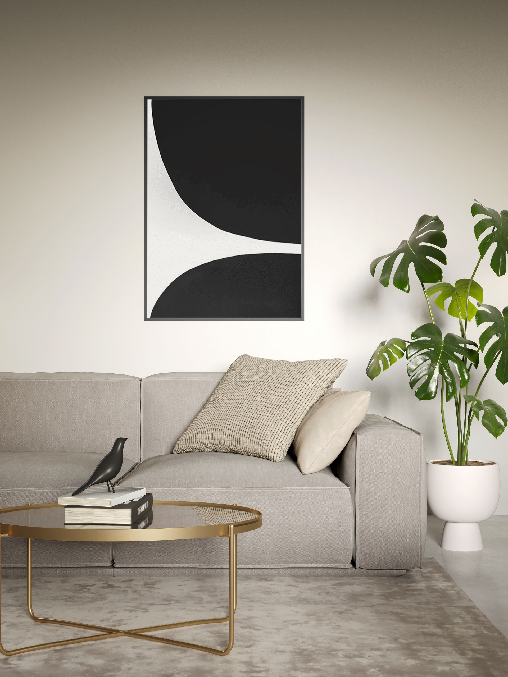 Living room with black and white artwork above a gray sofa, a Monstera plant, and a gold coffee table.