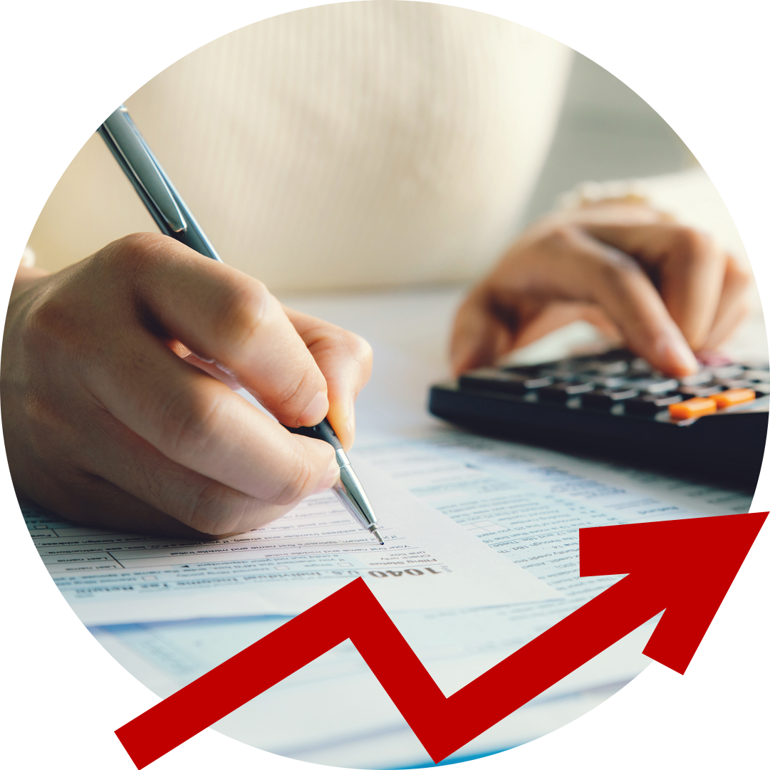 A person is using a calculator and writing on a piece of paper