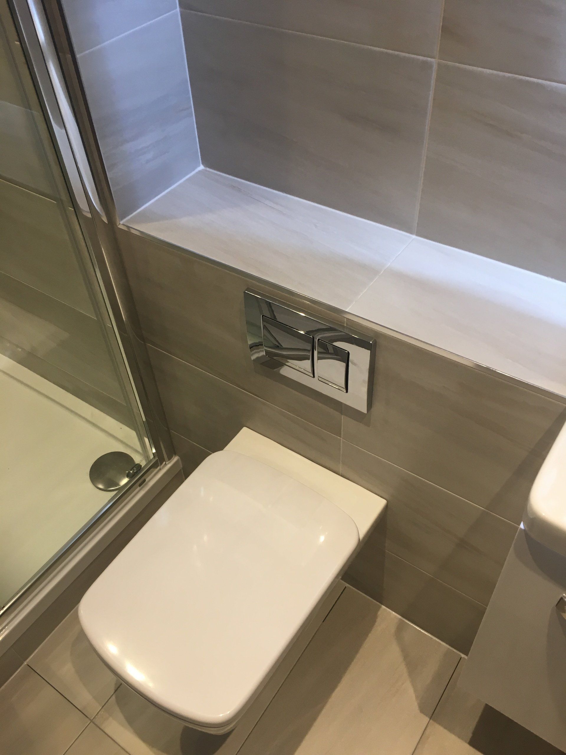 Beautiful ensuite bathroom with grey tiles wall hung WC