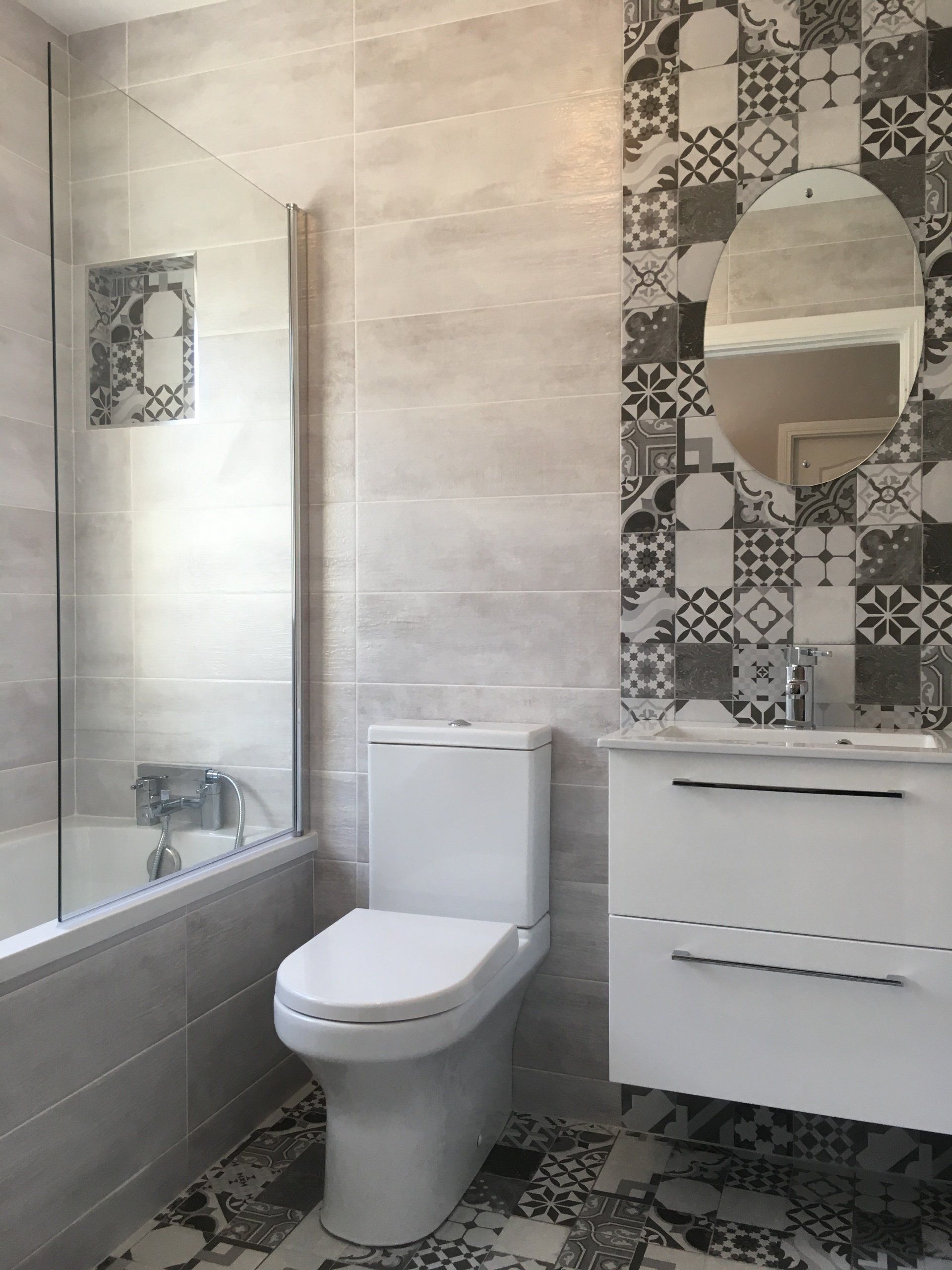 Bathroom black and white monochrome Morroccan patterned tiles white vanity unit and bath