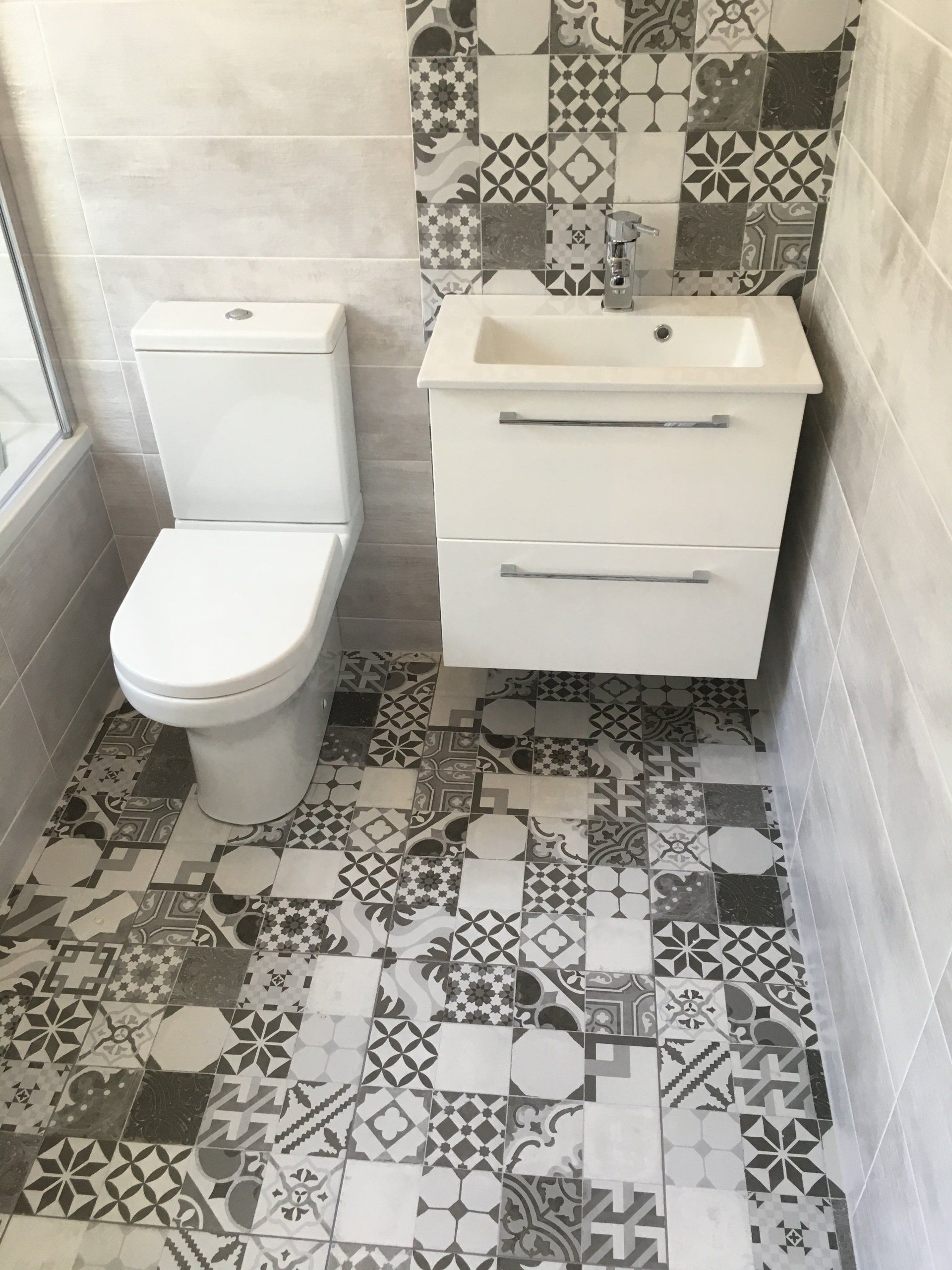Bathroom black and white monochrome Morroccan patterned floor tiles and white wall hung vanity unit