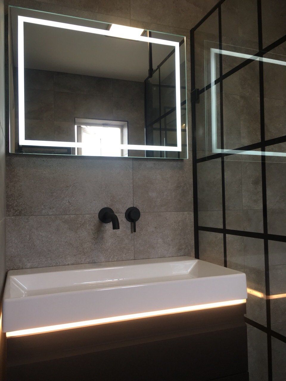 black wall mounted taps, black shower doors