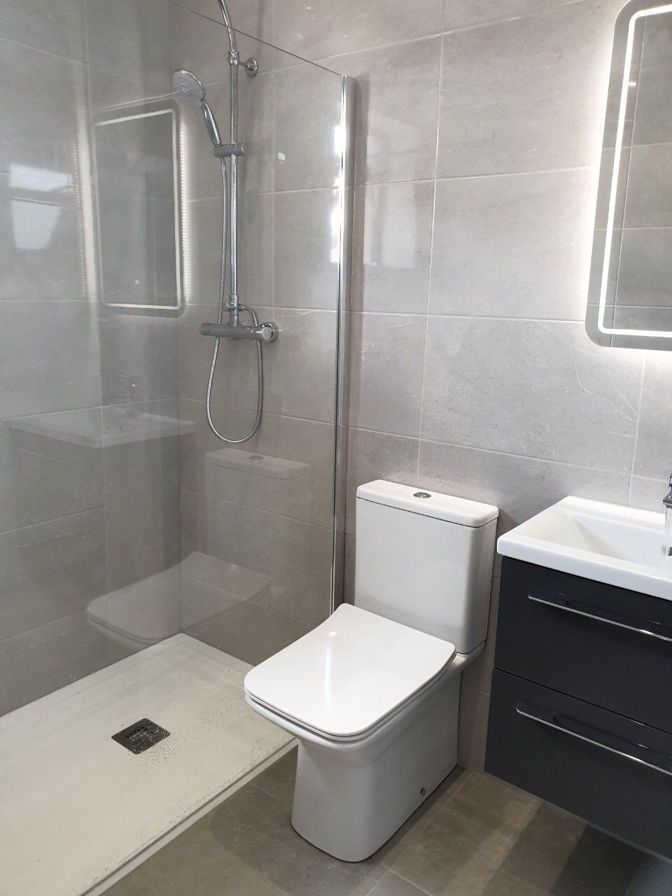 Bathroom renovation, Griffeen Bathrooms, Lucan, grey tiles, white slate tray, thermostatic shower kit, gloss grey vanity unit, wall hung vanity unit