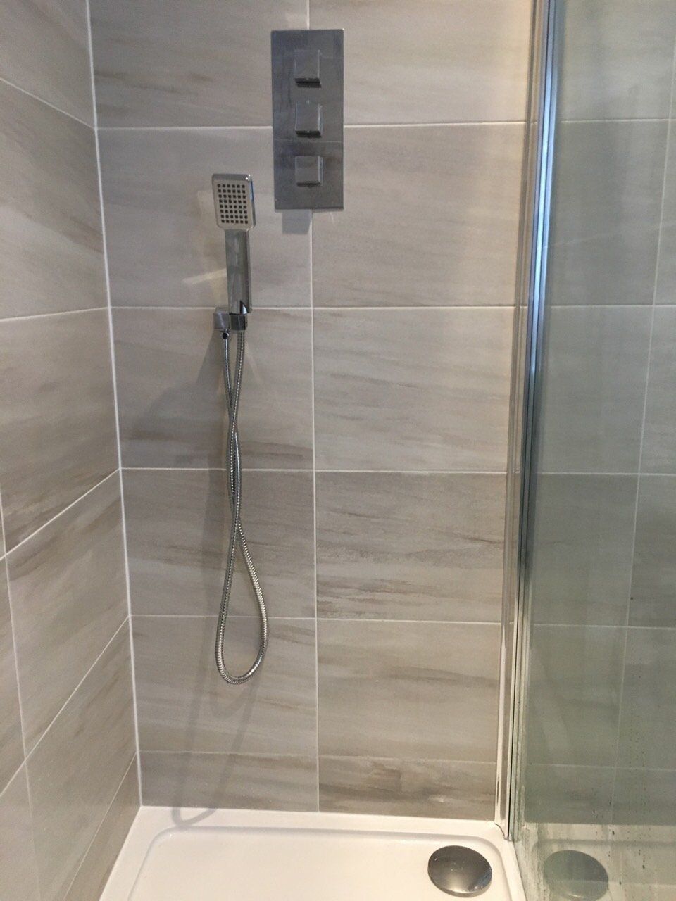 Bathroom grey tiles big shower and square concealed shower valve with handset
