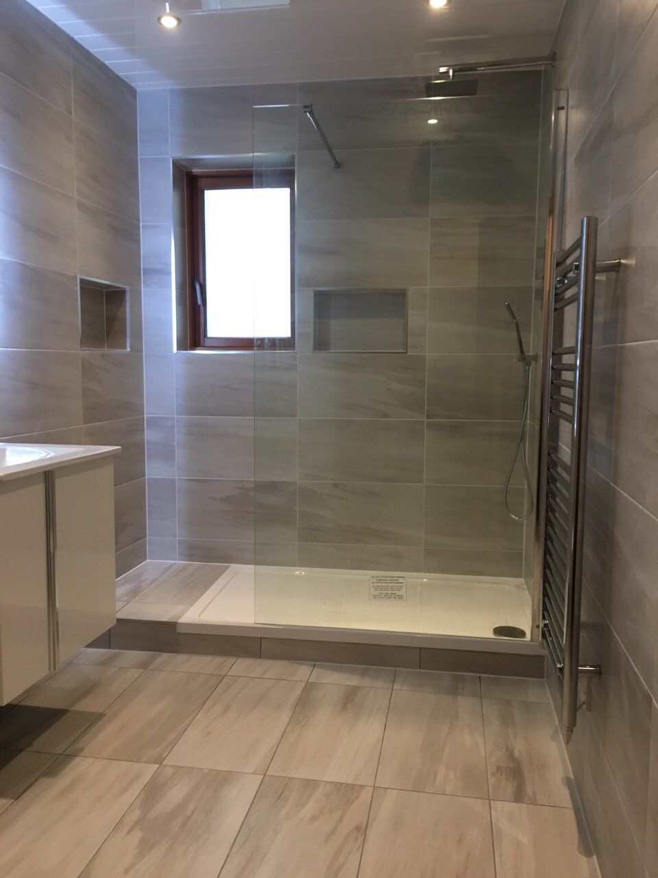 Big bathroom with walk in shower white wall hung vanity unit