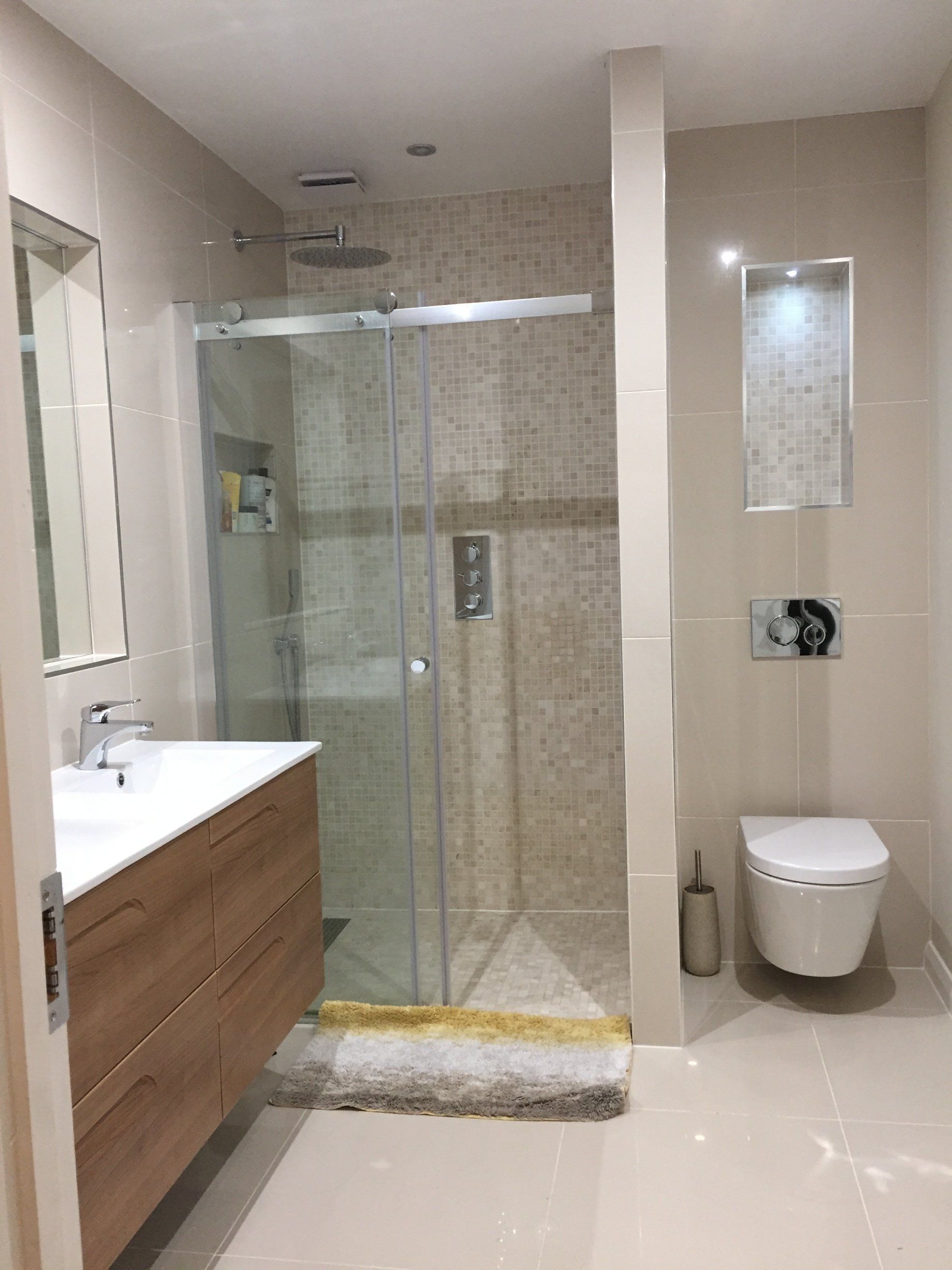 Bathroom with walk in shower, double wall hung vanity unit and cream tiles