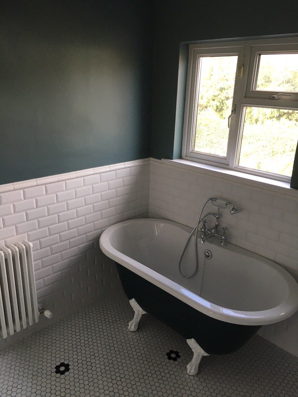Traditional style bathroom with freestanding bath and white subway tiles