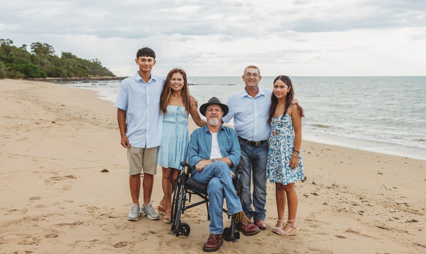 A woman is sitting next to a little girl in a wheelchair. — Collis Care In Dundowran, QLD