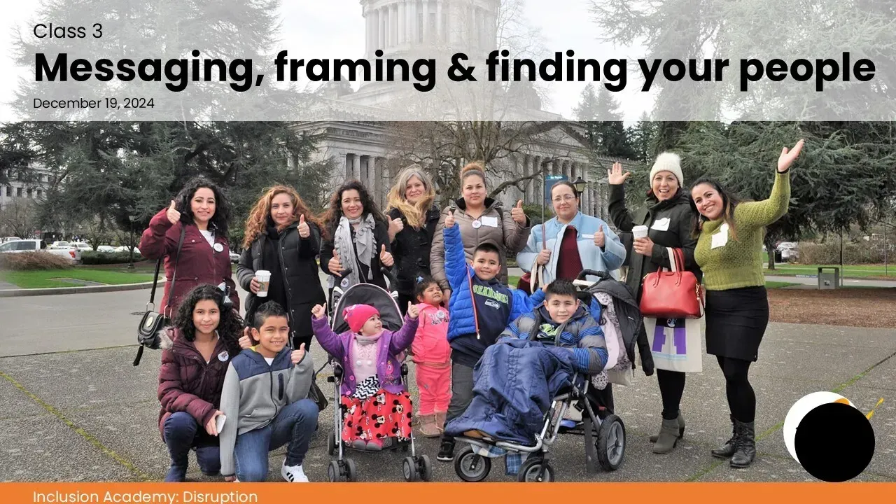 Group of people with and without disabilities in front of a building. Some are smiling and waving.