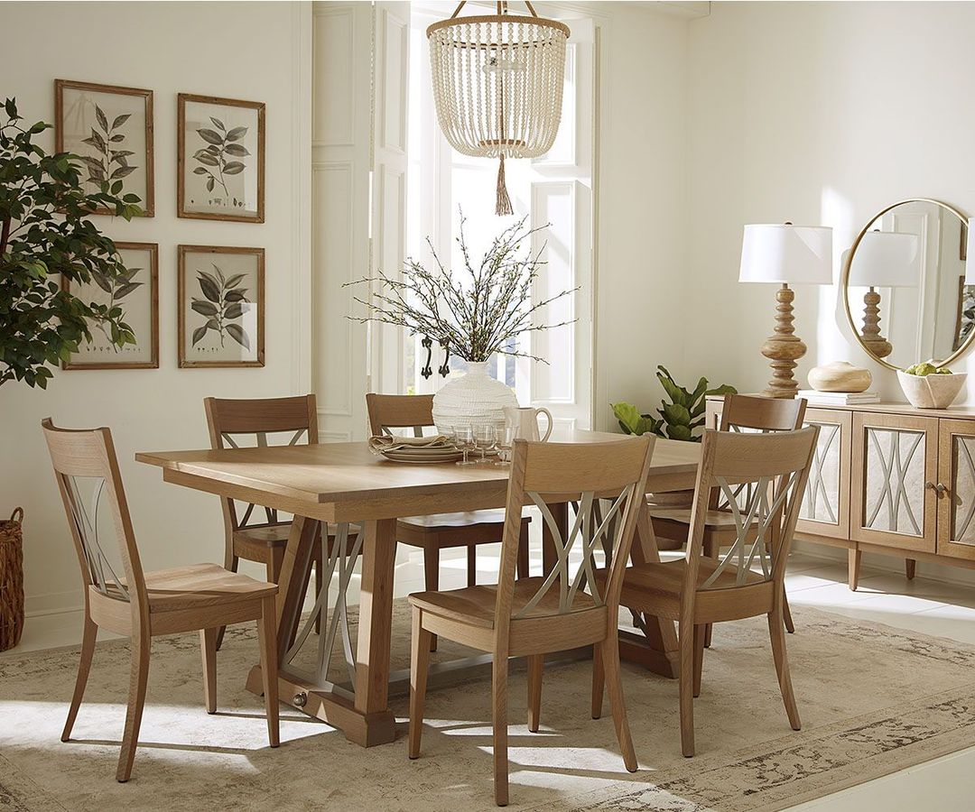 Dining room with wooden table, chairs, and sideboard; framed art; neutral tones.