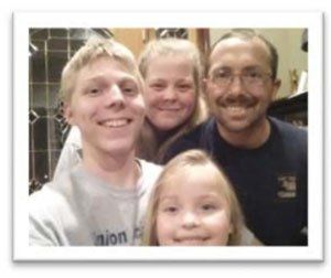 A family posing for a picture with a man wearing a union shirt