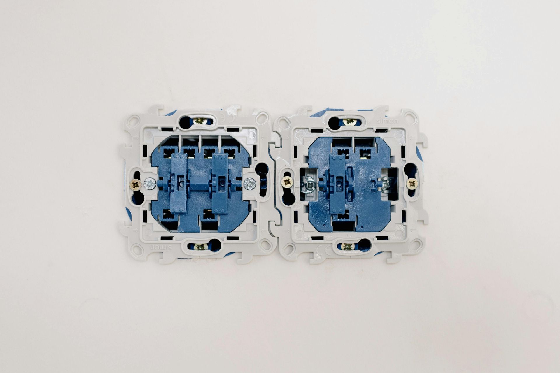 Two light switches are installed on a white wall.