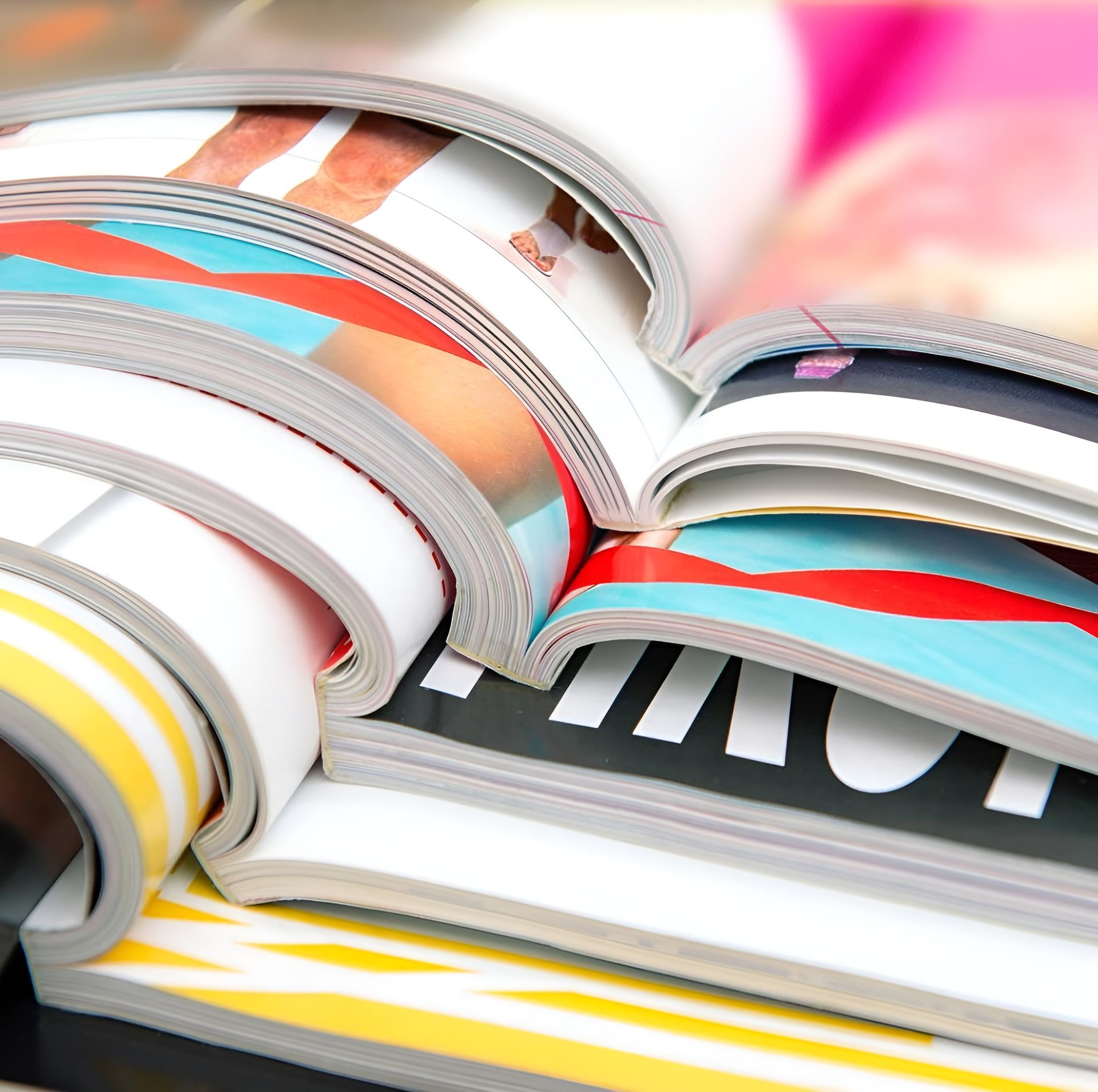 Stack of Colorful Magazines, Pages Open, Showing Images and Text — Digi Print Pro in Ballina, NSW