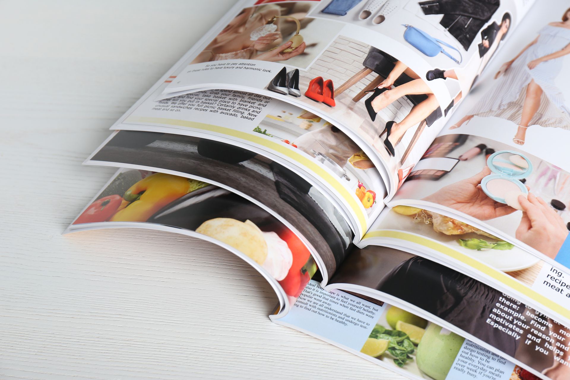 Open Magazines with Colorful Fashion and Food Photos on A White Surface — Digi Print Pro in Grafton, NSW