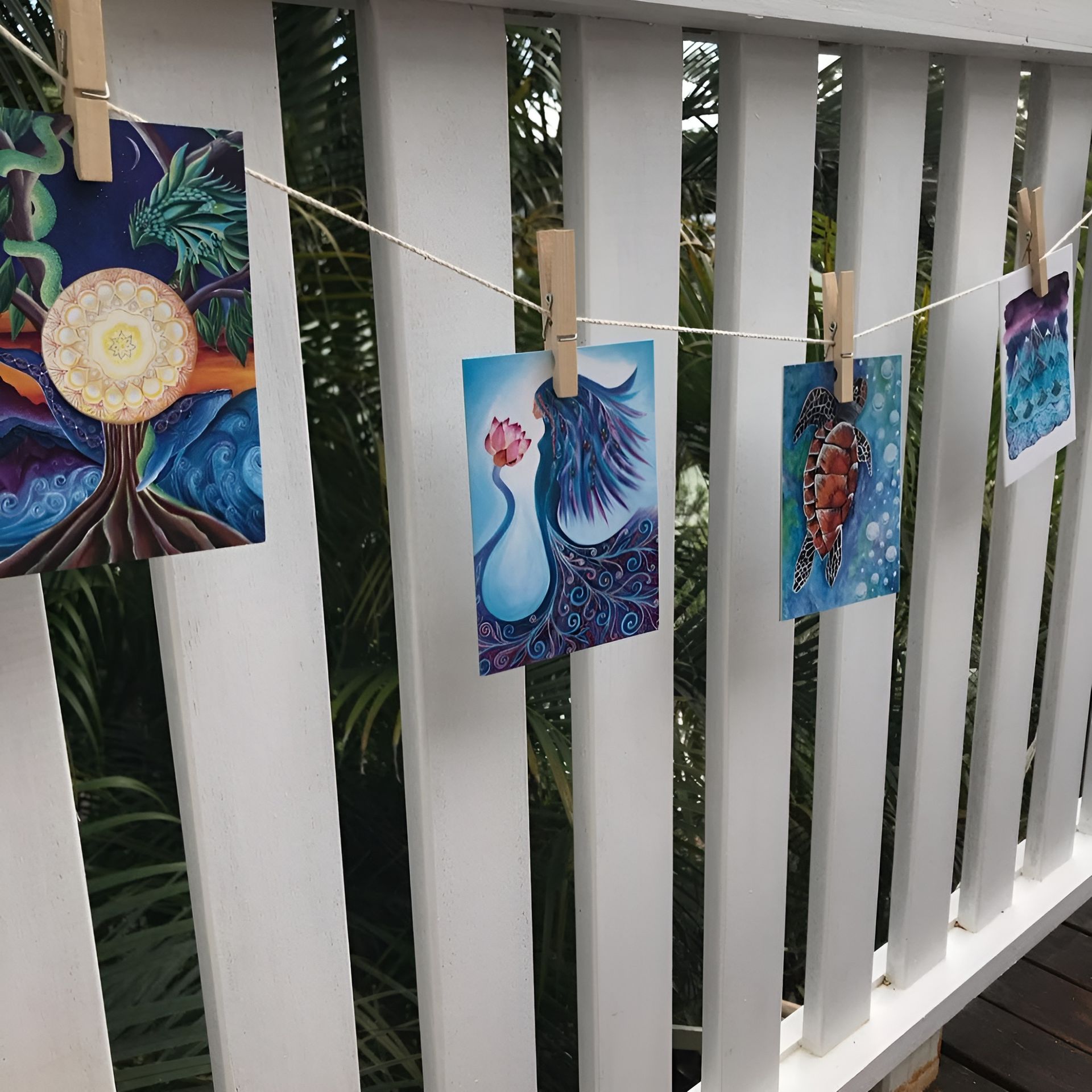 Art Cards Clipped to A Clothesline on A White Railing — Digi Print Pro in Bangalow, NSW