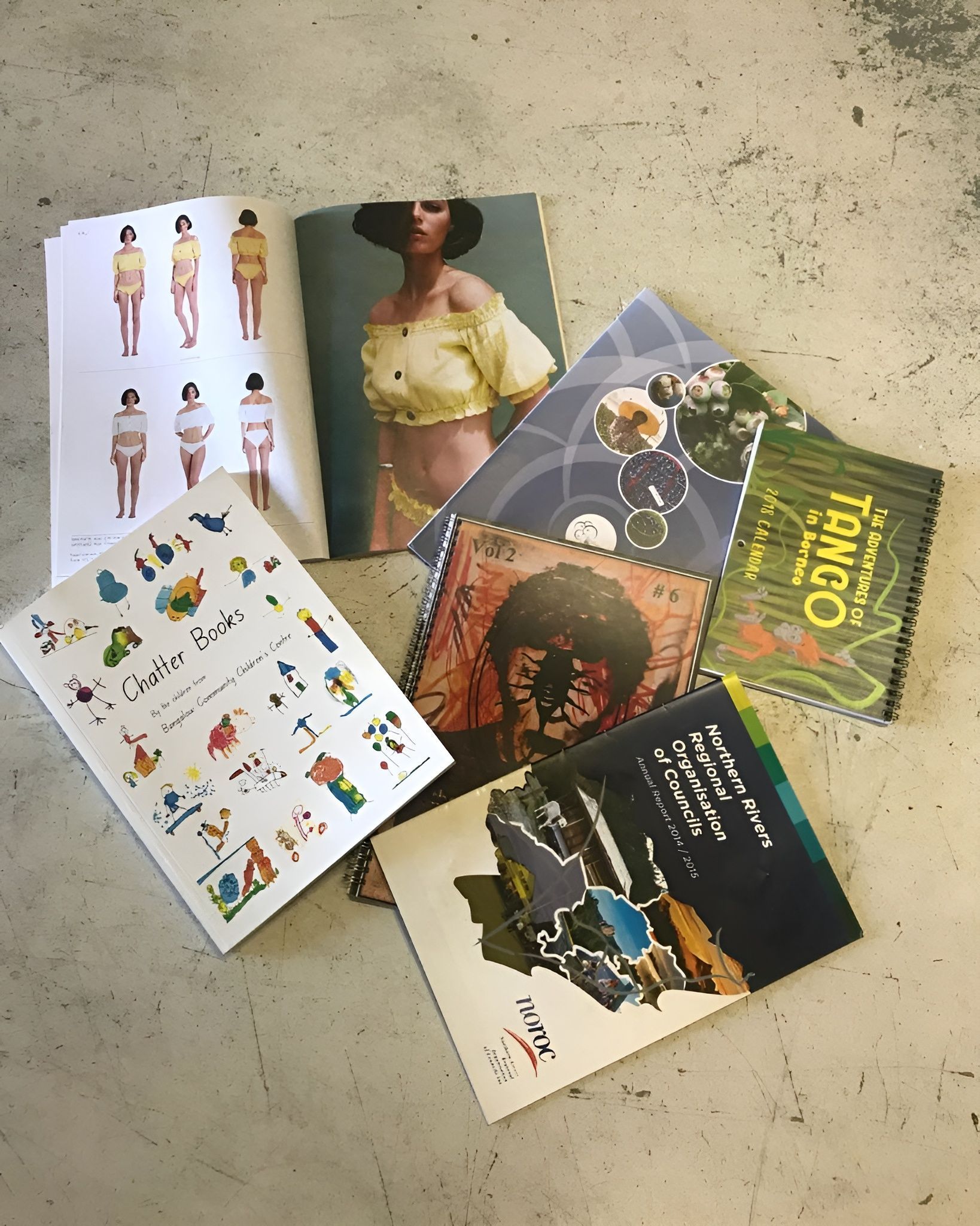 Pile of Colorful Books and Magazines on A Concrete Surface — Digi Print Pro in Casino, NSW