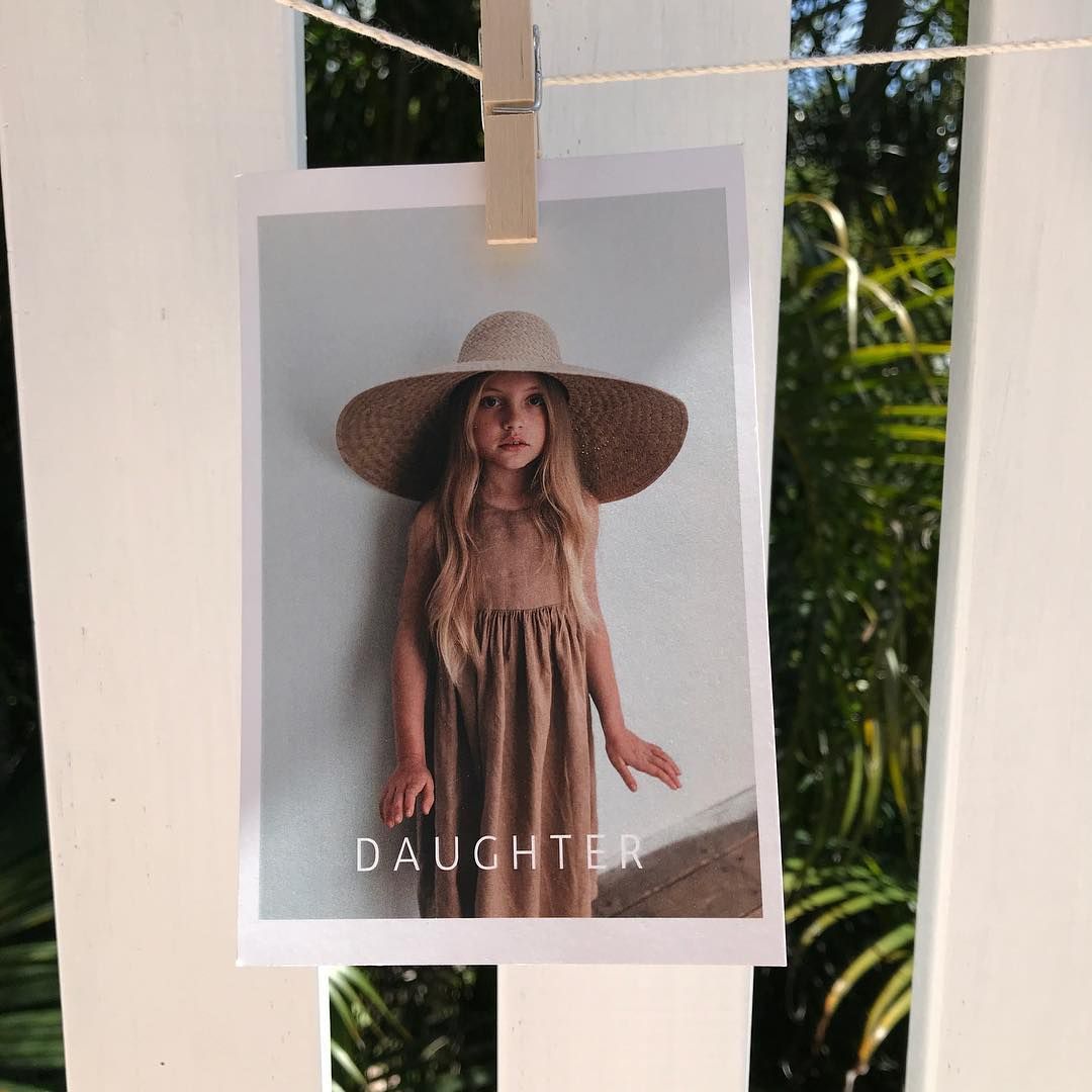 A Photo of A Young Girl Wearing a Hat and Dress Hanging on A Clothesline — Digi Print Pro in Brunswick Heads, NSW