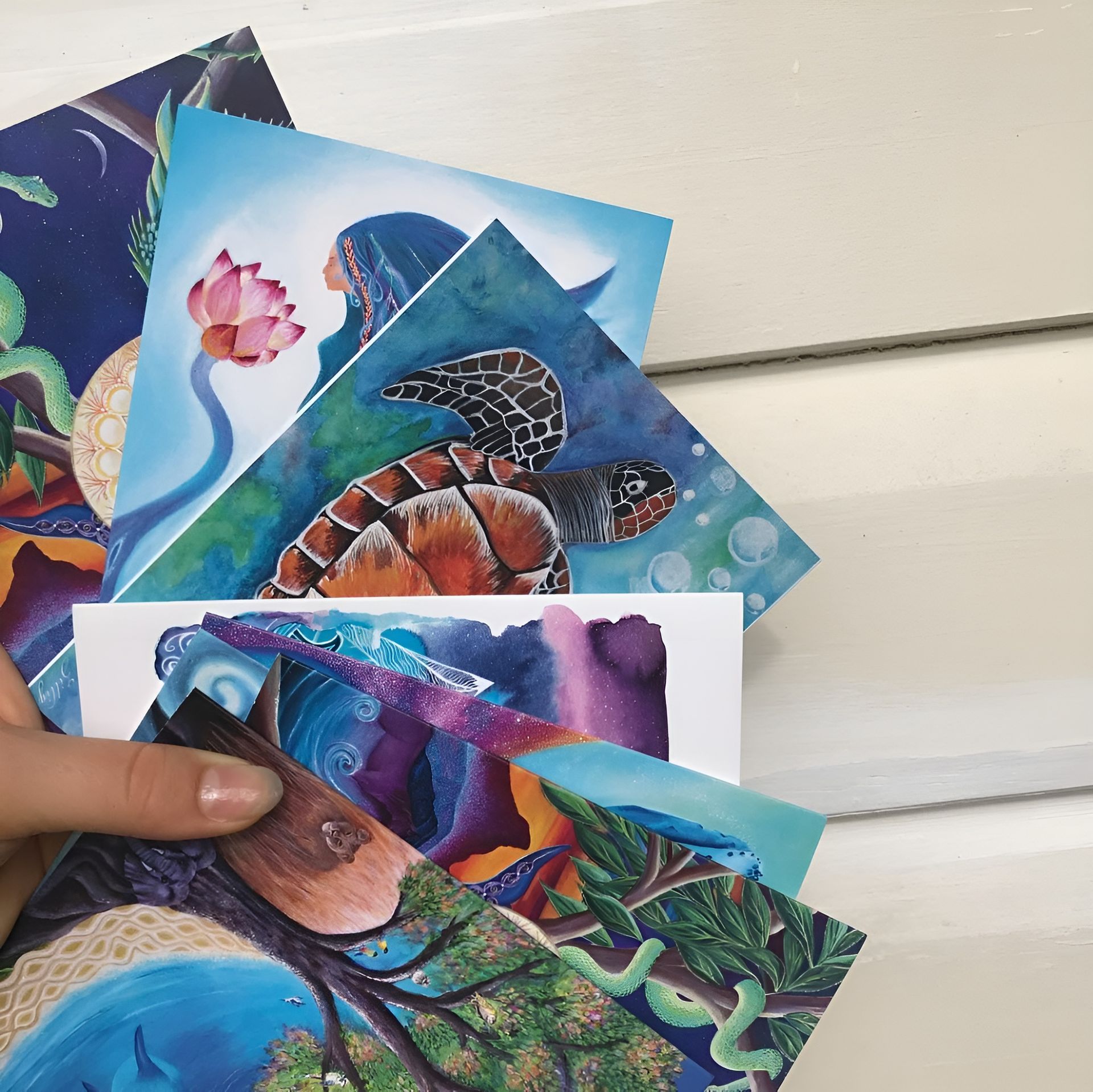 Hand Holding Assortment of Colorful Art Prints — Digi Print Pro in Bangalow, NSW