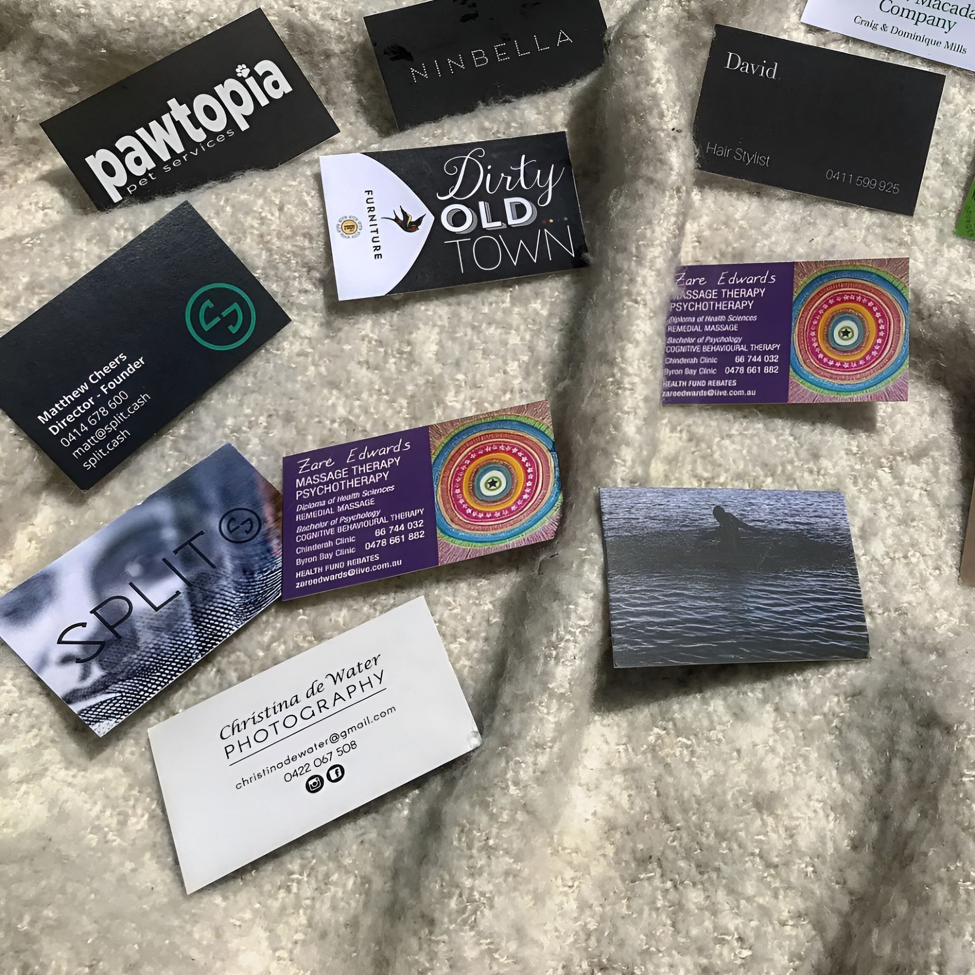 Assortment of Business Cards with Various Designs and Logos on A Light-Colored Surface — Digi Print Pro in Grafton, NSW