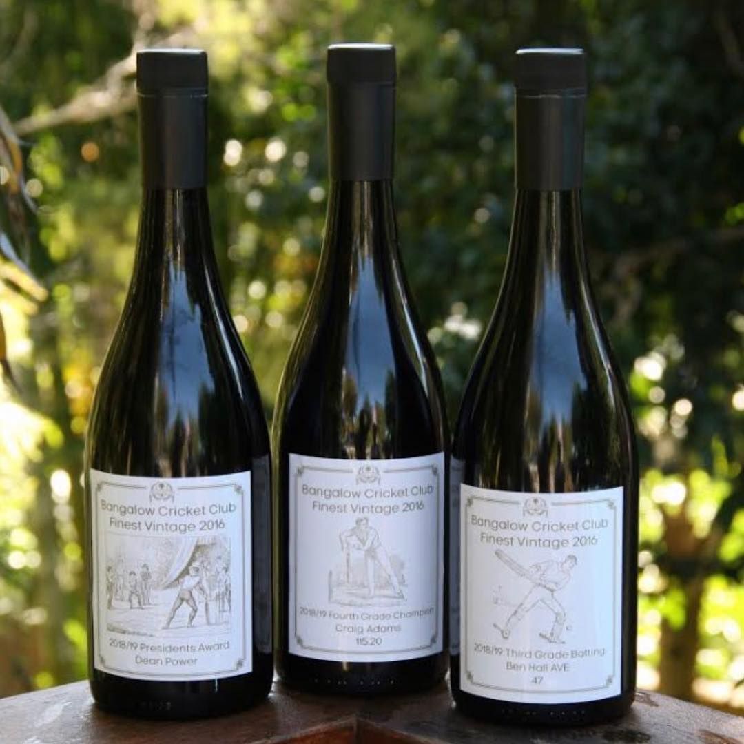 Three Wine Bottles with White Labels Against a Blurry Green Background — Digi Print Pro in Bangalow, NSW