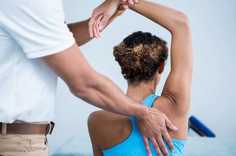 Chiropractors — Chiropractor Giving Shoulder Therapy To A Woman in Wenatchee, WA