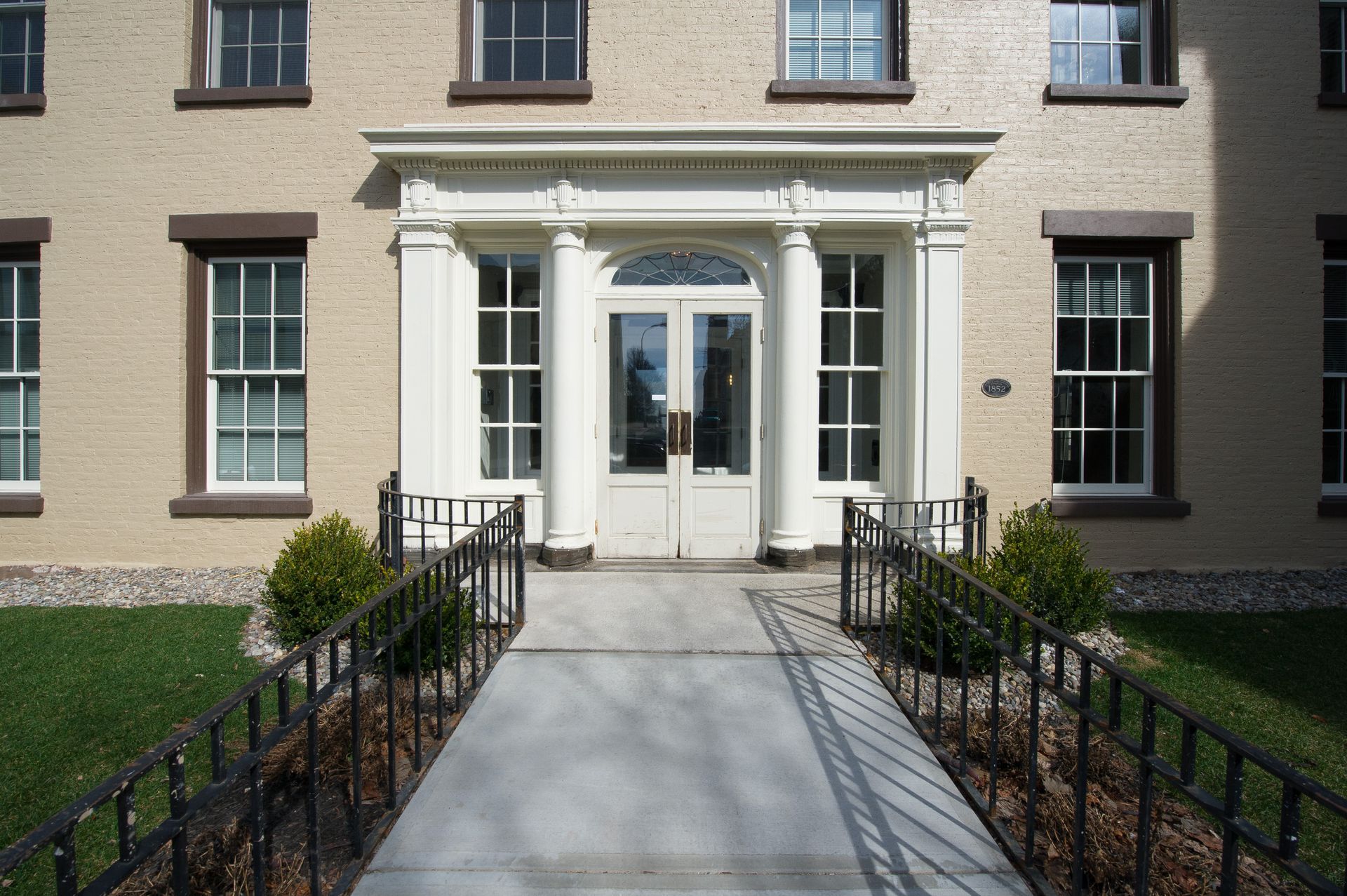 A brick building with a walkway leading to the front door