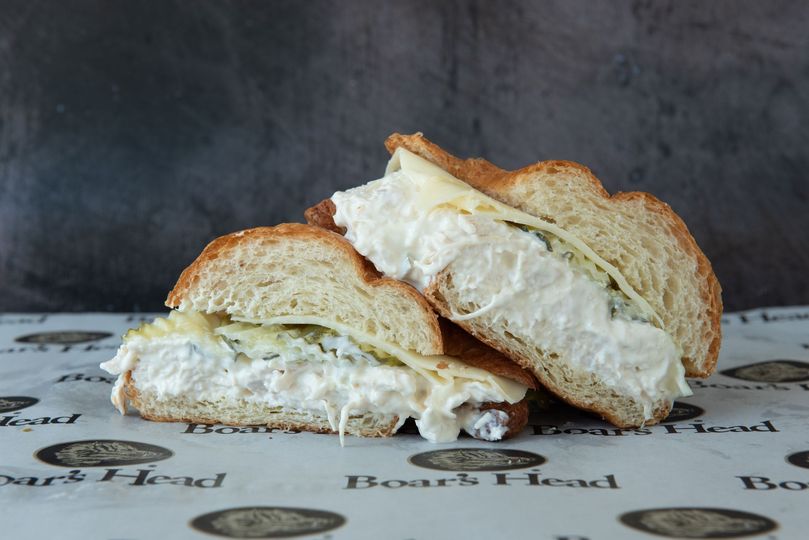 A sandwich is cut in half and sitting on a table.