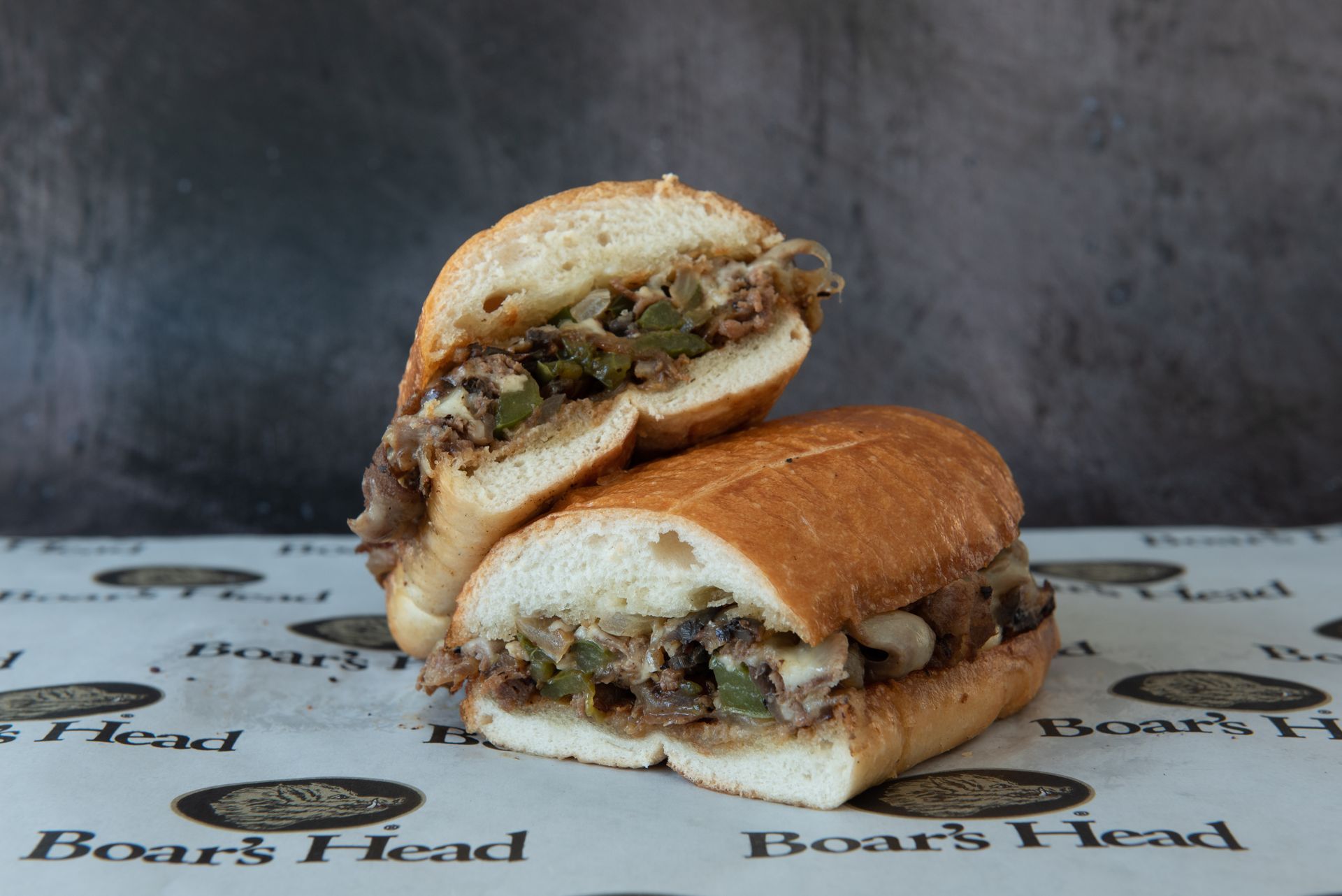 A sandwich is cut in half and sitting on a table.