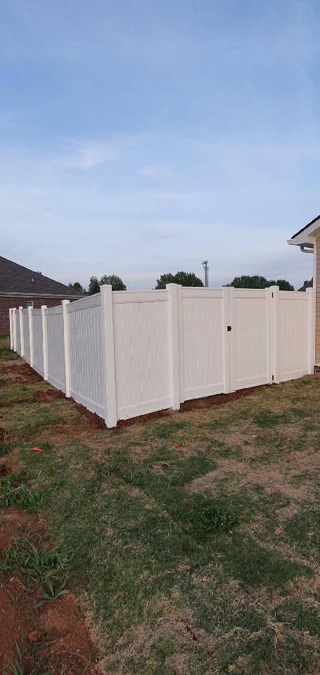 A white fence with a gate in the backyard of a house. Clarksville, TN