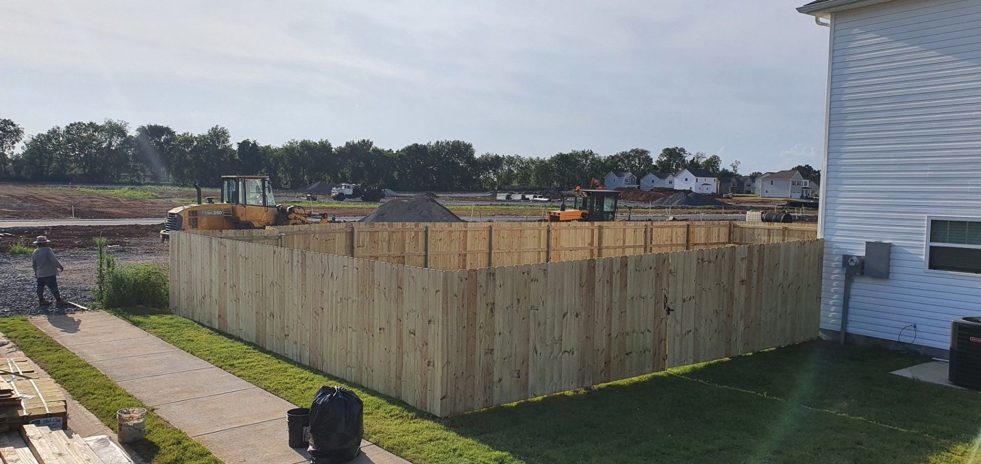 A wooden fence is being built in front of a house. Clarksville, TN