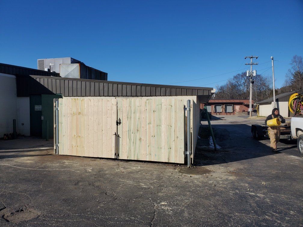 A wooden fence is being built in front of a building