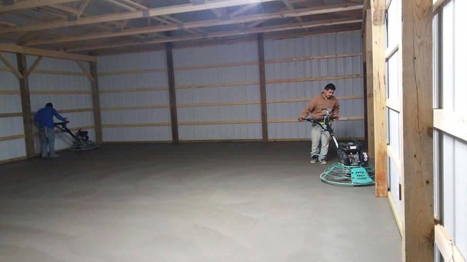 Indoor Garage Concrete Construction — Two Man Flatting the Concrete Floor  in Louisville, KY