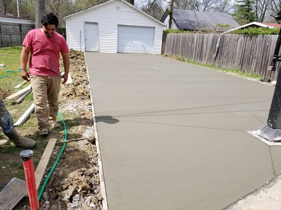 Concrete Inspection — Man beside the Concrete Flooring of the Garage in Louisville, KY