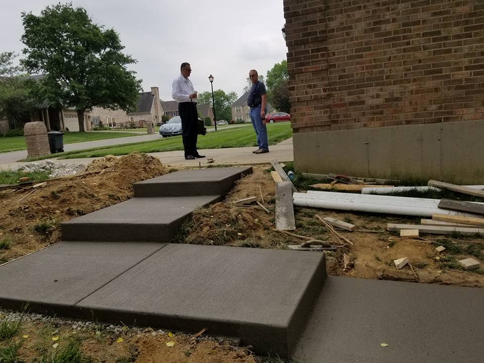 Concrete Builders — Owner Visiting the Garage Sidewalk Work in Louisville, KY